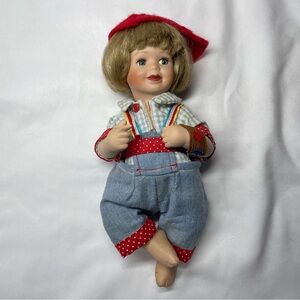 Vintage Porcelain Doll with Red and Blue Outfit